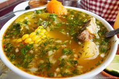 a white bowl filled with soup on top of a table