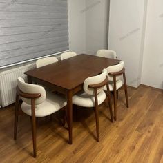 a wooden table with white chairs around it