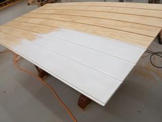 a wooden table being constructed in a workshop