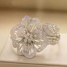 "Specification:- Stone Details :- *Diamond Material : Cubic Zirconia / Moissanite ( As Per Order ) *Diamond Cut : Round Cut  *Total Diamond Weight : 0.66 CT (Approx) *Diamond Dimension : 0.90, 1.00, 1.10, 1.20, 1.40 MM *Diamond Color: White  *Clarity : VVS *Making Process: Handmade by our Experienced Staff. *Stamp: Our All Rings Stamped According to metal Purity (925 SIL/10K/14K Gold). Customization:- *Buyer can Request change of rhodium color in 925 Silver Jewelry (No additional Charge). *In Gold (10K, 14K, 18K) buyer can change gold color (White, Rose, Yellow). *Buyer can also change CZ Stone Color (No additional Charge). Custom Order:- *We do Accept Custom order. *Buyer can also request customization in listed Items (Charges apply according to required Customization). Free Engraving:- * Moissanite Diamond Rings, Diamond Cocktail Rings, Big Flowers, 925 Silver Jewelry, Flower Ring, Moissanite Diamonds, Cocktail Ring, Bridal Rings, Ring Verlobung