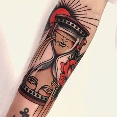 an arm with a clock and anchor on it