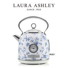 a white and blue floral kettle with a clock on the front, which reads laura ashley since 1953