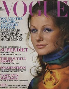 a magazine cover with a woman wearing blue eyeshadow and scarf on the front