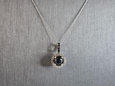 "A WOMENS VINTAGE ESTATE 10K WHITE GOLD PENDANT WITH BLACK & WHITE DIAMONDS.  NECKLACE MEASURES 21 1/2\" LONG AND THE PENDANT MEASURES 5/8\" BY 3/8\".  THE TOTAL WEIGHT IS 2.1g.  CENTER DIAMOND IS ABOUT .85cts, SURROUNDED BY 45 SMALL DIAMONDS.  MAKES A GREAT GIFT FOR THAT SPECIAL SOMEONE. ANY QUESTIONS, PLEASE ASK.  BE SURE TO CHECK OUT SOME OF OUR OTHER GREAT ITEMS." Formal Black Diamond Jewelry With Round Cut, Classic Black Diamond-cut Necklace, Formal Fine Jewelry Necklace With Black Diamonds, Formal Fine Jewelry Necklaces With Black Diamonds, Black Necklaces With Diamond Accents For Anniversary, Classic Black Diamond Necklace Gift, Formal Black Diamond Pendant Necklace, Black Hallmarked Round Necklaces, Black Hallmarked Round Pendant Necklace