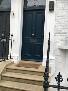 a blue front door on a white brick house