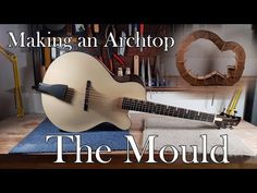 a guitar sitting on top of a wooden table