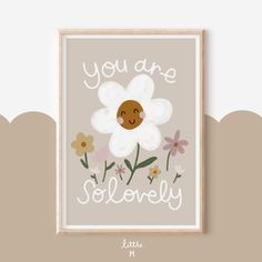 a white flower with the words you are lovely on it, in front of a beige background