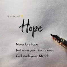 a fountain pen sitting on top of a piece of paper with the words hope written in it