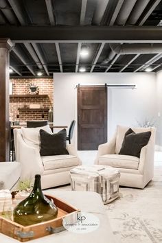 a living room filled with furniture and a wine bottle