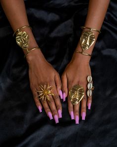 This beautiful African Mask Brass Statement Ring is the perfect accessory to make a statement. Crafted from high-quality brass and carefully detailed, this ring features an intricate traditional African tribal mask design. The stunning detail on the mask makes this ring a truly eye-catching piece. The band is adjustable and it provides a perfect balance for the impressive design and creates a timeless look that will add a touch of elegance to any outfit. Whether you choose to wear it with other African Jewelry Traditional, Gold Festival Jewelry Ring, Gold Festival Ring Jewelry, Gold Ring For Festivals, Gold Festival Ring, African Gold Jewelry, African Print Accessories, African Fabric Accessories, Afro Jewelry