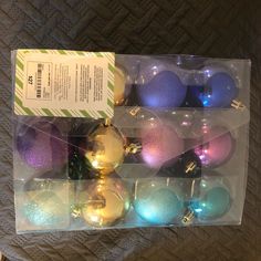 there are many different colored ornaments in the package