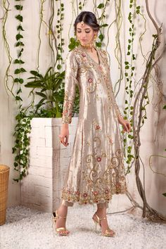 Pure soft tissue multi-paneled A-line shirt with slits in stunning golden hue, features intricate zardozi, tila and floral embroidery in a mix of antique gold & silver dabka, nakshi, sequins & pearls, stunning coral and deep maroon florals offset golden base add a festive touch and enhances zardozi work. The complementing pure atlas silk ombre dupatta featuring hand-made resham tassels & straight tissue pants adds to the regal look of this outfit- a must have for any celebratory occasion. Shirt Sims Closet, Ombre Dupatta, Order Dresses Online, Pakistan Bridal, Shadi Dresses, Australia Clothes, Zardozi Work, Pakistani Couture, Designer Outfit