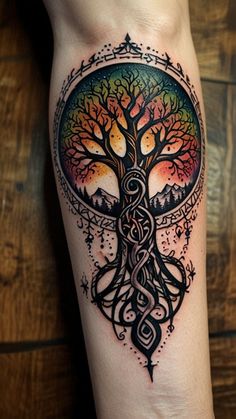 a woman's leg with a tree tattoo on it and an intricate design in the middle