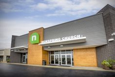 a large building with a green and white sign on it's front door that says keeping church