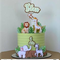 a birthday cake with animals and trees on it