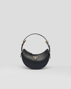 Black Prada Arqué Leather Mini Shoulder Bag | PRADA Designer Baguette Shoulder Bag With Adjustable Strap, Luxury Baguette Shoulder Bag With Detachable Handle, Luxury Baguette Shoulder Bag With Detachable Strap, Black Calf Leather Shoulder Bag With Gold-tone Hardware, Luxury Shoulder Bag With Adjustable Strap And Round Handle, Timeless Black Shoulder Bag With Round Handle, Designer Shoulder Bag With Round Handle, Black Calf Leather Shoulder Bag With Palladium Hardware, High-end Leather Handles Shoulder Bag For Evening