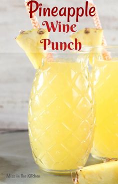 pineapple wine punch in a pitcher with two pieces of fruit next to it and the title overlay reads pineapple wine punch