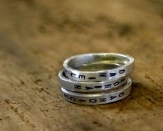 Personalized silver stamped stacking rings by monkeysalwayslook at etsy Meaningful Engraved Silver Stackable Rings, Silver Stamped Stackable Promise Rings, Personalized Silver Stackable Rings, Silver Hand Stamped Stackable Promise Rings, Personalized Silver Engraved Ring, Silver Sterling Silver Engraved Ring For Birthday, Personalized Silver Engraved Ring For Birthday, Customizable Silver Stackable Rings For Personalized Gifts, Birthday Engraved Silver Sterling Ring