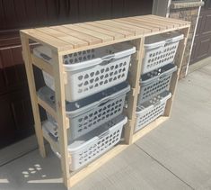 three white plastic baskets stacked on top of each other in front of a garage door