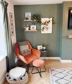 a living room filled with furniture and pictures on the wall next to a window in front of a tv