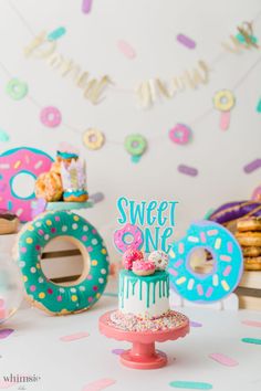 there is a cake and donuts on the table