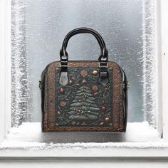 Get into the holiday spirit with this festive handbag featuring a Christmas tree designed to look like intricately tooled leather, giving it a charming Western boho vibe. The unique design captures the essence of the season, bringing holiday cheer and a touch of rustic elegance to your everyday style. Crafted from high-quality PU leather, this cute bag combines durability with a playful seasonal flair, making it perfect for any holiday outing.  With black handles and a removable, adjustable buck Unique Christmas Gift, Christmas Tote, Western Christmas, Christmas Tree Design, Western Boho, Soft Bristle Brush, Unique Christmas Gifts, Limassol, Black Handle