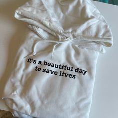 a white hoodie with the words it's a beautiful day to save lives written on it