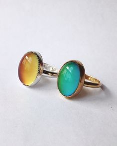 "This ring features a 13x18mm oval Mood stone bezel set in a handmade serrated bezel. The band is a thick half-round. The mood stone changes colors varying from yellow, green, blue, and purple! A small heart is stamped into the back of the ring :) I can also add an arrow or letter/number(s) or your choice if you prefer, just let me know in the note to seller section! You can choose from sterling silver, 14k yellow gold-fill, or 14k rose gold-fill. If you would prefer a different karat or type of Green Oval Opal Ring With Bezel Setting, Oval Cabochon Jewelry With Smooth Bezel For Gift, Adjustable Green Oval Opal Ring, Yellow Oval Cabochon Gemstone Jewelry, Yellow Oval Jewelry With Bezel Setting, Yellow Oval Rings With Bezel Setting, Yellow Oval Ring With Bezel Setting, Multicolor Oval Cabochon Opal Ring, Yellow Oval Cabochon Gemstone Ring