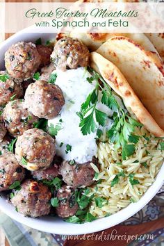 a plate with meatballs, rice and pita bread