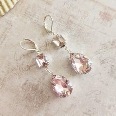 Handmade rhinestone drop earrings feature light pink 18x13mm pear (teardrop) rhinestones that are suspended from 14x10mm light pink octagonal rhinestones set in silver tone metal settings. Stones dangle from silver plated lever backs and measure 2" long.  First 3 pics of these rhinestone drop earrings are taken in natural light all others in LED light. Colors may vary slightly between monitors. All metal used in these rhinestone drop earrings is lead and nickel free. These handmade light pink rhinestone drop earrings would make a great gift. Please see my shop policies for more information: http://www.etsy.com/shop/milminedesign/policy How to care for your jewelry: To keep your rhinestone drop earrings looking great, please store in a sealed, air-tight zip lock bag. Do not wear your rhines Teardrop Pink Rhinestone Jewelry, Pink Teardrop Rhinestone Jewelry, Pink Drop Crystal Earrings For Party, Pink Teardrop Earrings For Formal Occasions, Pink Teardrop Crystal Earrings, Teardrop Crystal Earrings With Rhinestones For Gift, Teardrop Crystal Earrings With Rhinestones, Handmade Lighting, Feature Light