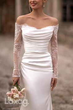 a woman in a white wedding dress holding a bouquet