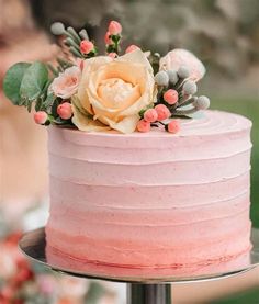 a pink frosted cake with flowers on top