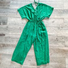 New With Tag Never Been Worn Size Small Stretchy Can Fit Size Small And Medium Loose Fit Jumpsuit Green Wide Leg Green V-neck Jumpsuit For Loungewear, Green Overall Jumpsuit For Day Out, Green Overall Jumpsuits And Rompers For Vacation, Green Tie Waist Jumpsuit For Work, Casual Green Jumpsuits And Rompers For Brunch, Green Tie-waist Jumpsuits And Rompers For The Beach, Green Tie Waist Jumpsuit For The Beach, Green Tie Waist Jumpsuit For Beach, Green Jumpsuit With Tie Waist For The Beach