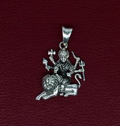 Indian Hindu Idols Blessing Goddess Bhawani/Durga/Santoshi maa with lion vintage antique style stunning divine pendant, best gifting unisex jewelry from India. Metal-925 sterling silver. Item type-Pendant Weight-5.860 grams. Height-4.0 centimeter. Width-2.2 centimeters. Stamped-925. Finish-Oxidized. note: chain is not included in this price. Make excellent gifting and collectible pieces(gifts for birthdays, weddings, anniversaries, mother's day, fathers day, Christmas day,) We take absolute care Symbolic Jewelry For Puja And Navratri, Symbolic Jewelry For Navratri Puja, Sterling Silver Pendant Necklace For Diwali, Sterling Silver Jewelry For Diwali, Sterling Silver Jewelry For Puja And Festivals, Sterling Silver Necklace For Puja And Diwali, Sterling Silver Necklace For Diwali Puja, Silver Symbolic Jewelry For Diwali, Sterling Silver Jewelry For Diwali Puja