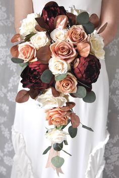 a bride holding a bouquet of flowers in her hands