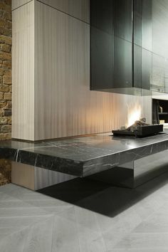 a modern kitchen with black cabinets and marble counter tops