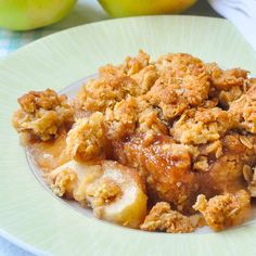 a close up of a plate of food with apples in the background