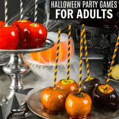 halloween party games for adults with apples and oranges on a silver platter next to candles