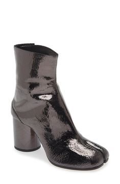 Inspired by the Japanese tabi sock, this iconic split-toe boot is made from supple leather and set on a cylindrical heel that keeps the palette monochromatic. 3" (76mm) heel (size 38.5) 6" shaft Hook closure Leather upper, lining and sole Made in Italy Women's Designer Shoes Tabi Work Boots, Tabi Boots Black, Split Toe Boots, Maison Margiela Tabi Pumps, Maison Margiela Tabi Boots, Tabi Socks, Tabi Boots, Footwear Design Women, Designing Women