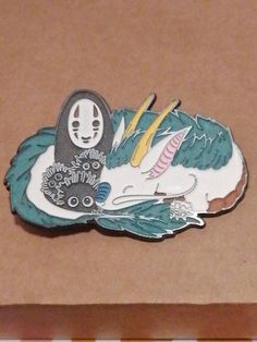 a close up of a brooch on a piece of paper with a cat in it