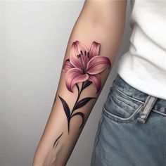 a woman with a flower tattoo on her arm