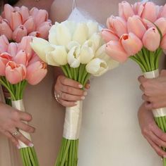 the bridesmaids are holding their bouquets with pink and white tulips