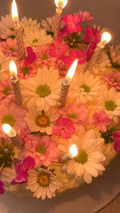 a cake with flowers and candles on it