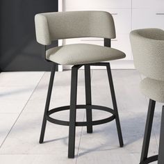 two stools in the middle of a kitchen with a counter top and cabinets behind them