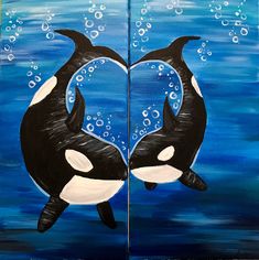 two black and white orca whales in the ocean with bubbles forming a heart shape