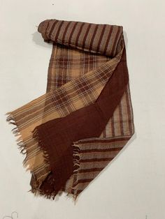 "This 3 in one brown Designer scarf is skilfully crafted with 3 layers of very soft pure woollen fabrics of same brown tone.  That  is Brown checked,Brown plain and brown stripes soft woollen fabrics are beautifully and skilfully woven together at one end, leaving the other ends open to use these different pattern fabrics of scarf separately depends on your requirements.That makes 3 different scarves in this one single Designer scarf. How amazing!! This Designer scarf is made from very light, fi Brown Plain, Woolen Scarves, Designer Scarf, Brown Scarves, Crystal Trim, Designer Scarves, Casual Winter Outfits, Gold Threads, 3 In One