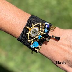 Hand embroidered by artisans in Chiapas, Mexico, these bracelets are a must have in your jewelry collection of handmade and unique. Adjustable. 8 inches long. 2 inches wide. Spiritual Beaded Cuff Bracelet Gift, Handmade Adjustable Charm Bracelet For Festivals, Adjustable Black Handmade Bangle, Handmade Adjustable Black Bangle, Adjustable Handmade Black Bangle, Bohemian Hand Wrapped Wristband Gift, Bohemian Hand Wrapped Wristband As Gift, Resizable Bangle Jewelry For Festivals, Traditional Resizable Bracelets As Gift