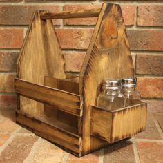 a wooden caddy with two glass bottles in it