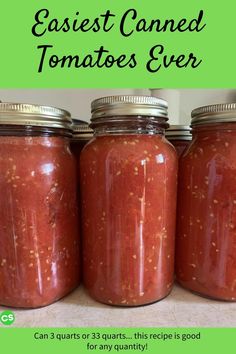 three jars filled with tomato sauce sitting on top of a counter