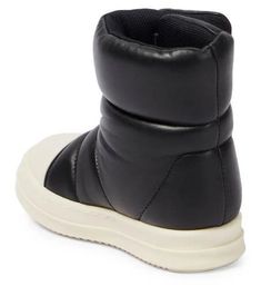 They'll master the art of cool dressing with Rick Owens Kids’ off-kilter wardrobe staples like these puffer boots. Made from quilted leather, they have shark-tooth rubber soles and feature flaps that wraps around the ankles..Upper: lamb leather.Lining: leather.Sole: leather insole, rubber sole.Toe shape: round toe.Made in Italy.Closure: VELCRO® fastening.Comes with dust bag.Comes with a box.European sizes.Insole length size 19 = 12cm-4.5'.Insole length size 20 = 12,5cm-5'.Insole length size 21 = 13cm-5'.Insole length size 22 = 13,5cm-5.5'.Please note that, for a comfortable fit, the shoe should be up to 1.5cm longer than the kid's feet Low-top Winter Boots With Textured Sole, Quilted Winter Boots With Round Toe, Winter Streetwear Boots With Textured Sole, Rick Owens Jumbo Lace, Rick Owens Outfit, Puffer Boots, Shark Tooth, Shark Teeth, Quilted Leather